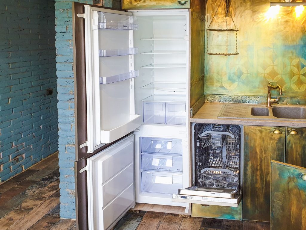 Open refrigerator and dishwasher in a clean modern kitchen