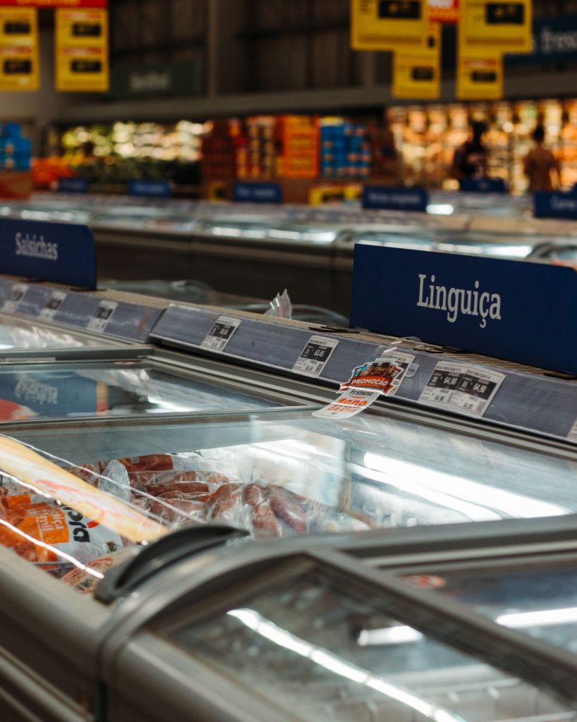 Refrigerated supermarket display of frozen meat products