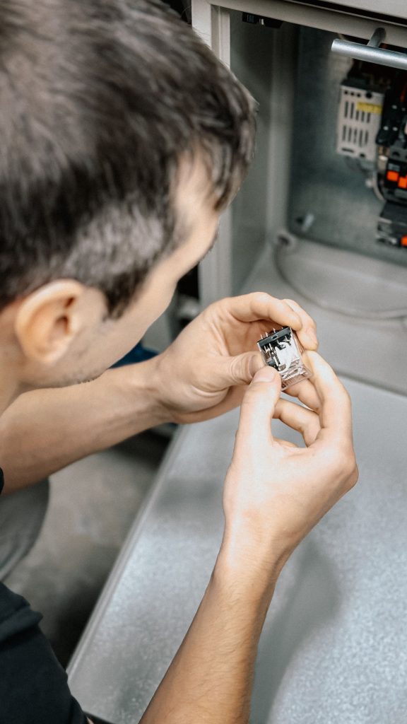 Technician inspecting a small mechanical component