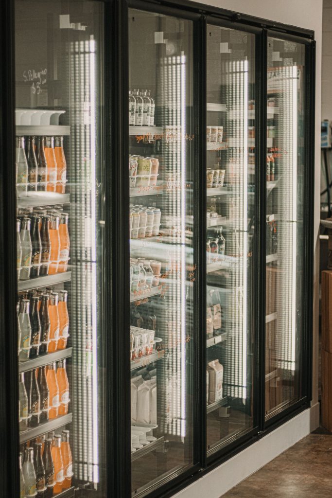 Well-lit refrigerated beverage display in a grocery store